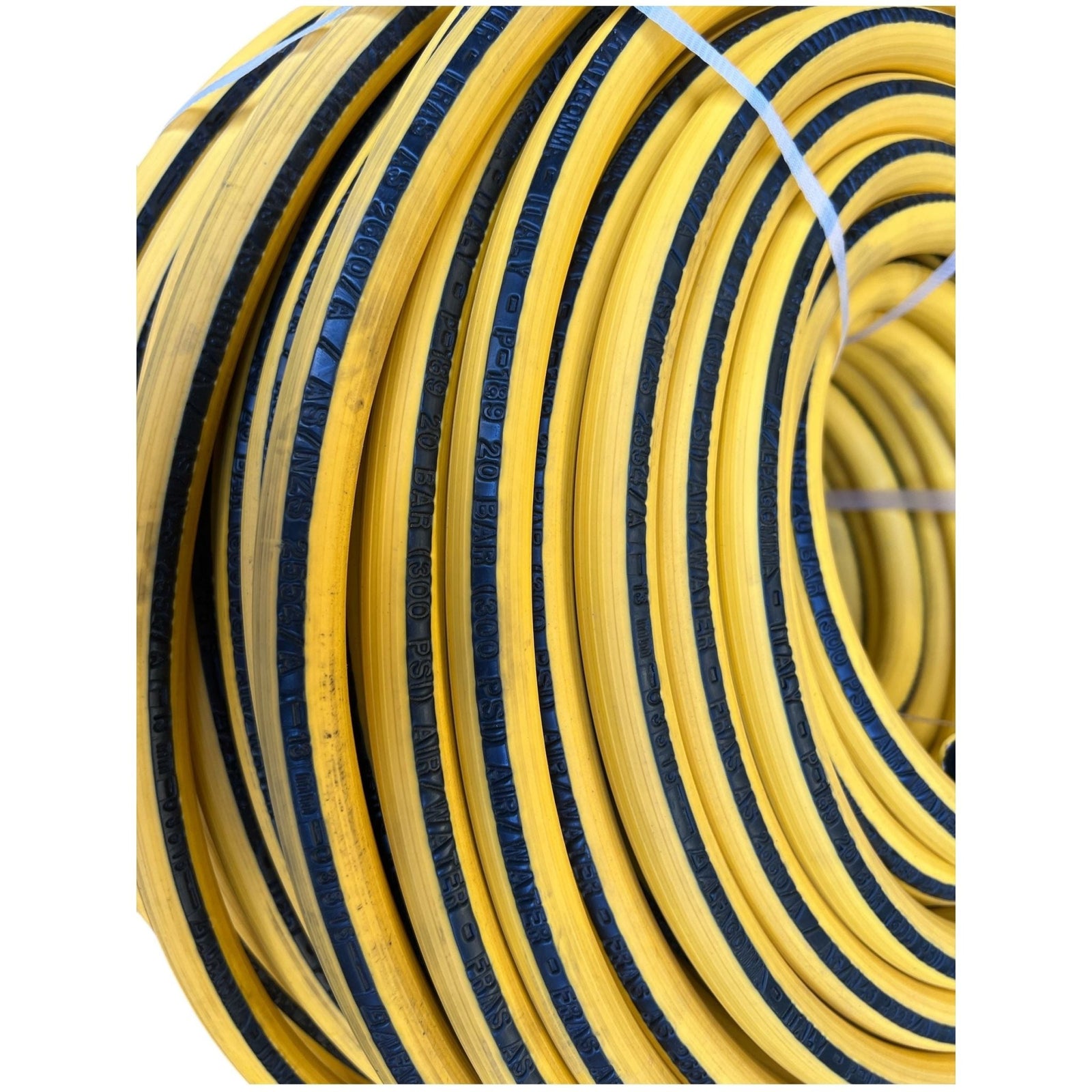 ALFAGOMMA P-189 FRAS Hose coils showcasing the yellow with black stripe design, perfect for various applications.