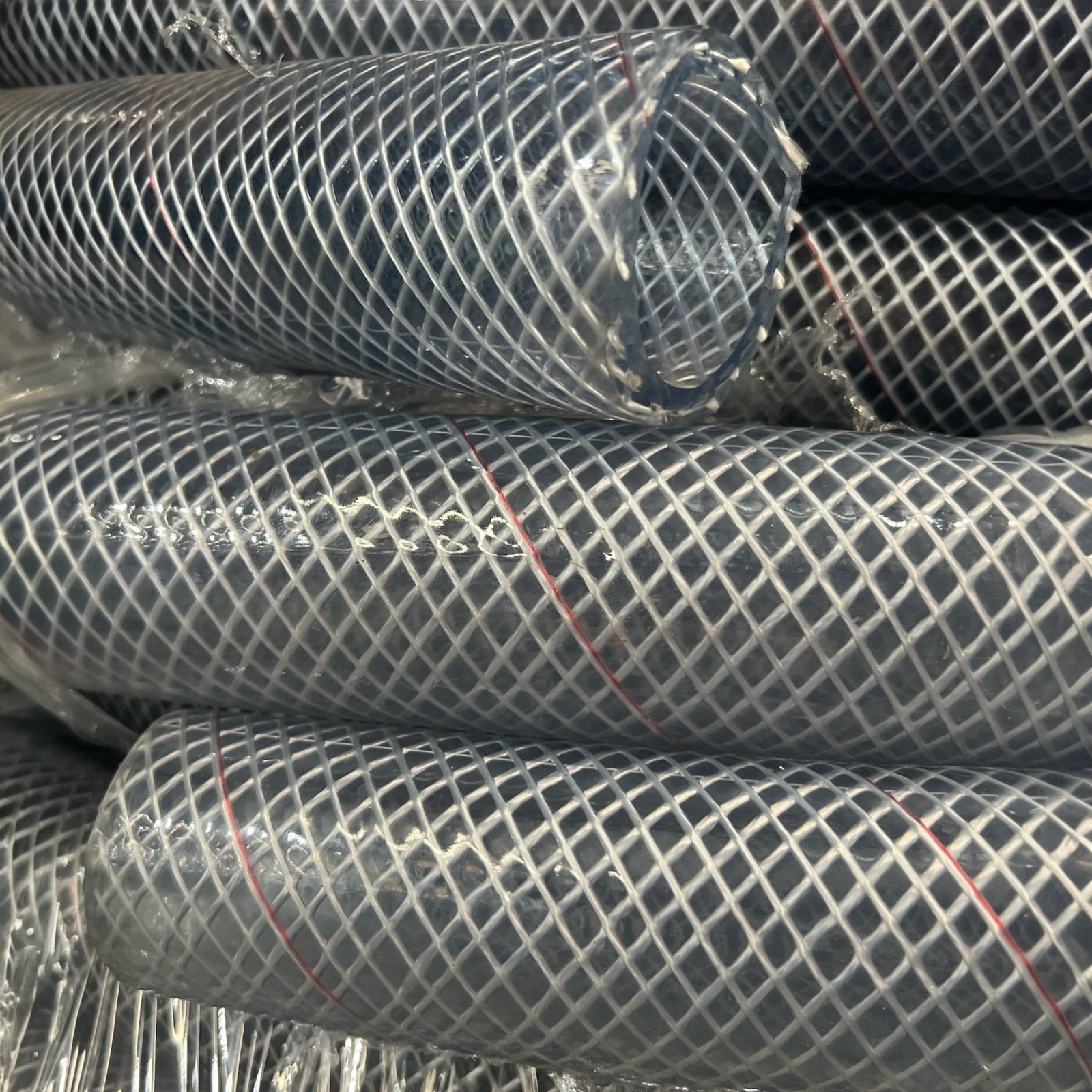 Clear Multi Purpose Hose Air Chemical Fuel 38mm stacked in protective covering on display.