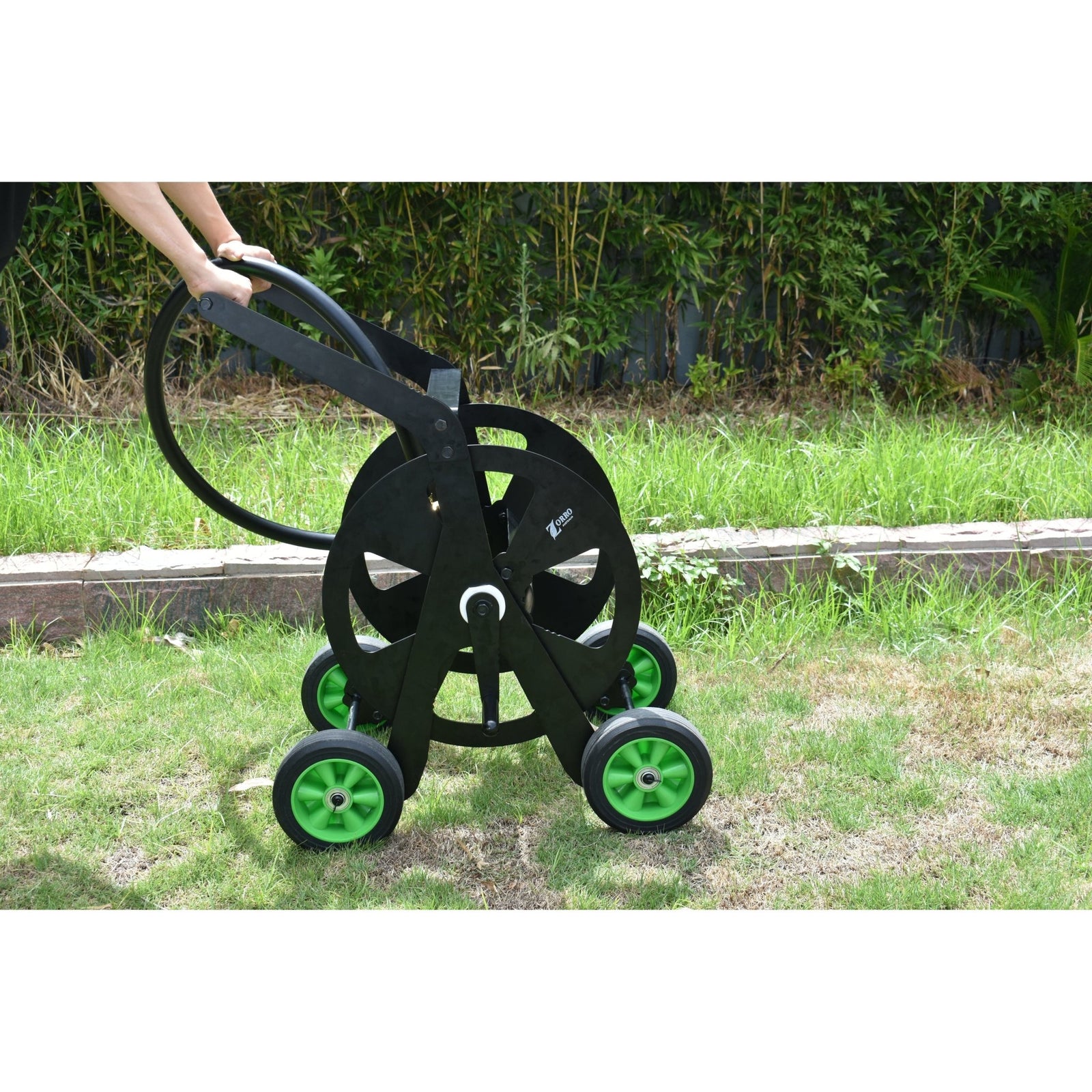 ZORRO Pro Industrial Hose Trolley and Proline with green wheels on a lawn, showing durability and portability.