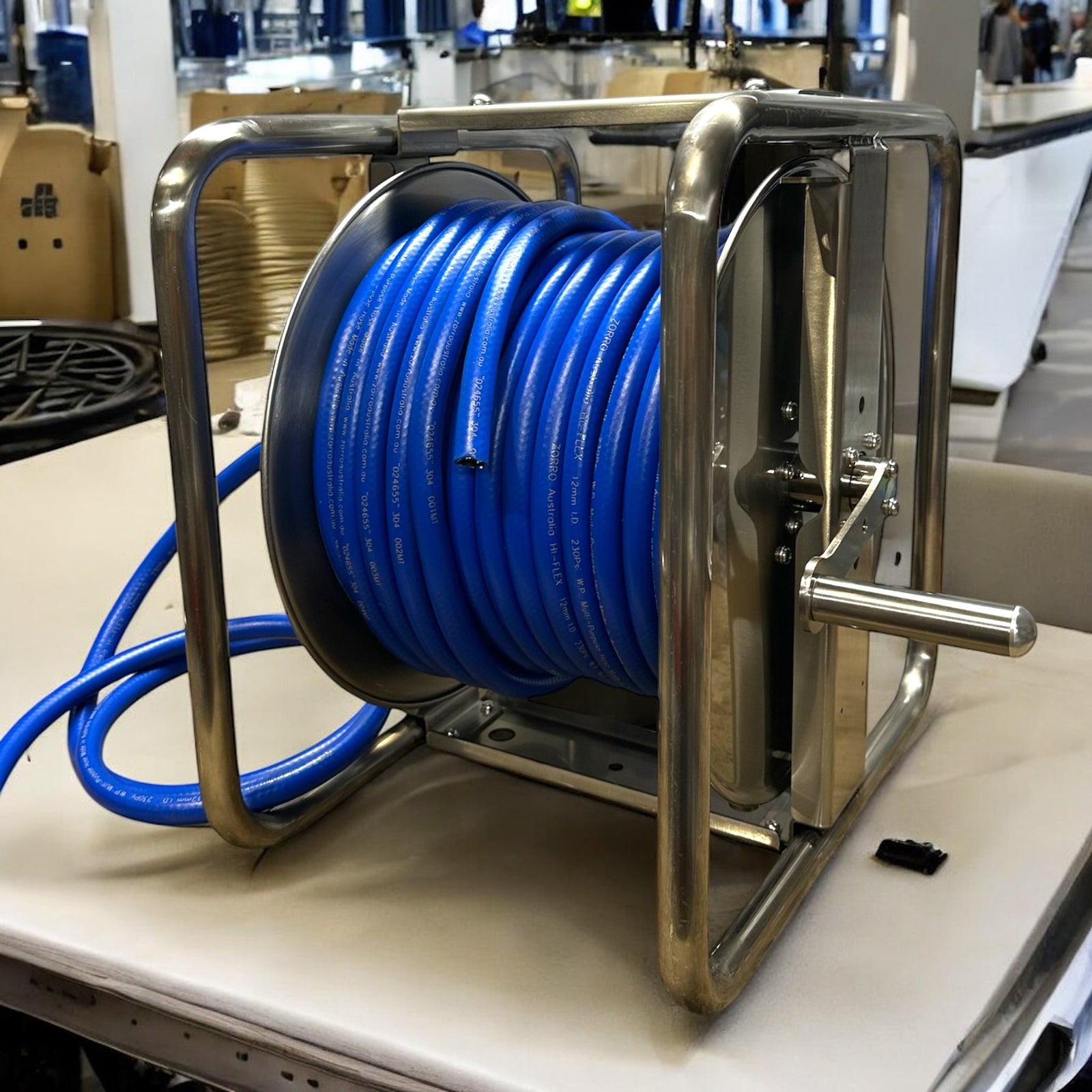 ZORRO PRO Stainless Steel Reel & Hi-Flex air, chemical, and water hose bundle showcasing the blue hose on a stainless steel reel.
