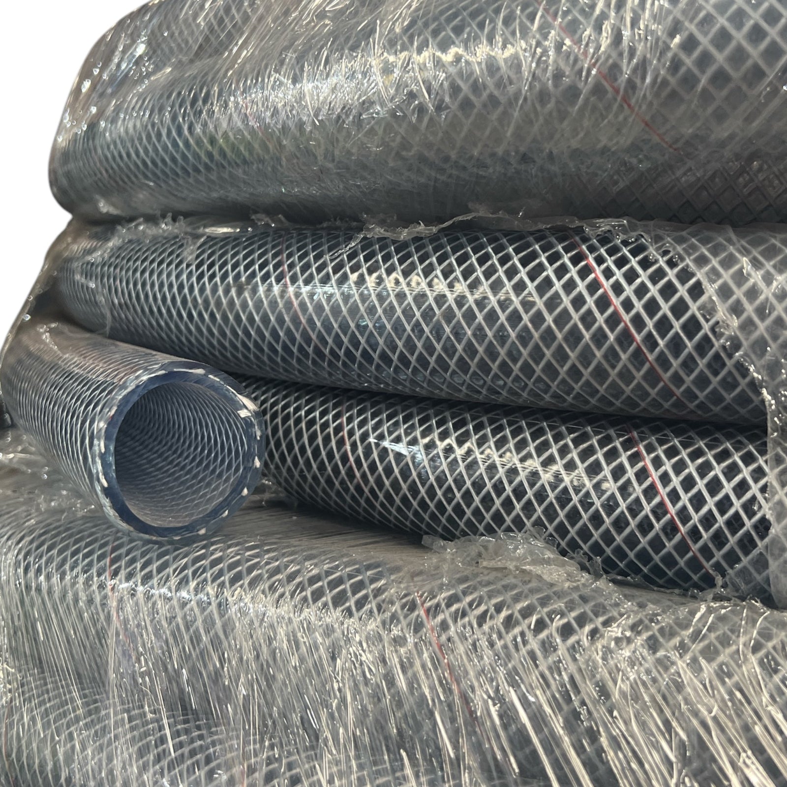 Clear Multi Purpose Hose Air Chemical Fuel 38mm stacked rolls in protective wrapping.